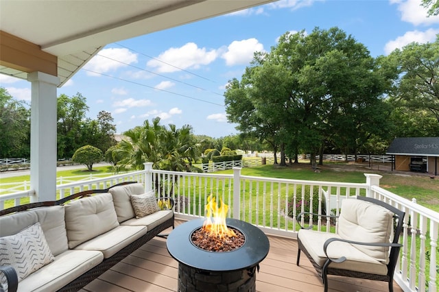 deck featuring an outdoor living space with a fire pit and a yard