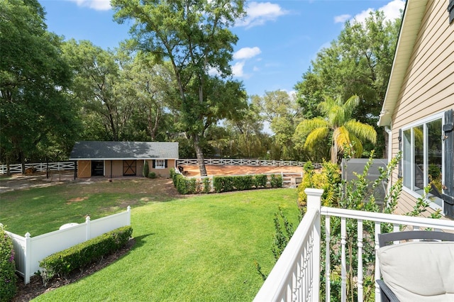 view of yard with fence private yard and an outdoor structure