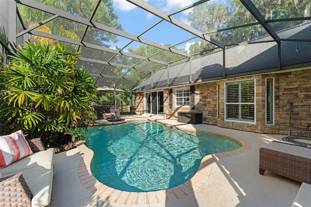 outdoor pool featuring a patio, a hot tub, and glass enclosure