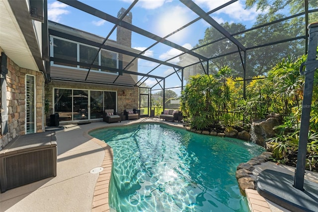 outdoor pool with a patio, outdoor lounge area, and a lanai