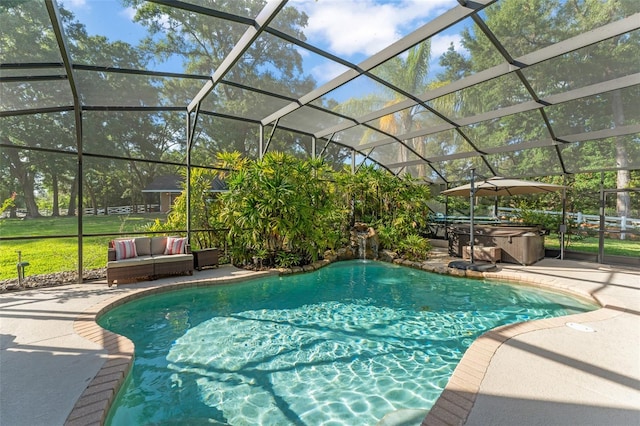 outdoor pool with a hot tub, a patio area, and glass enclosure