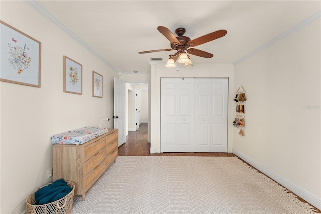 interior space with baseboards, ornamental molding, wood finished floors, and visible vents