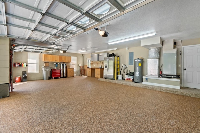 garage featuring stainless steel fridge, a garage door opener, electric water heater, heating unit, and electric panel