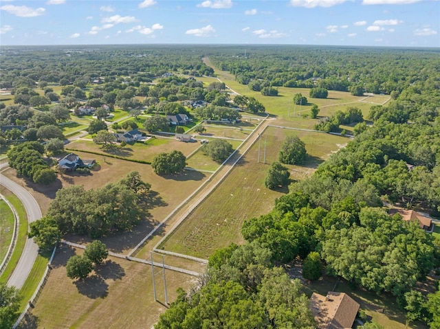 birds eye view of property featuring a wooded view