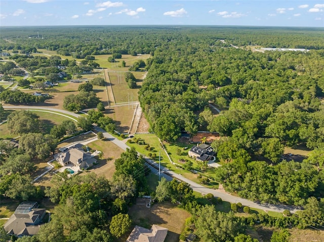 birds eye view of property with a view of trees