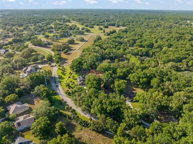 drone / aerial view featuring a forest view