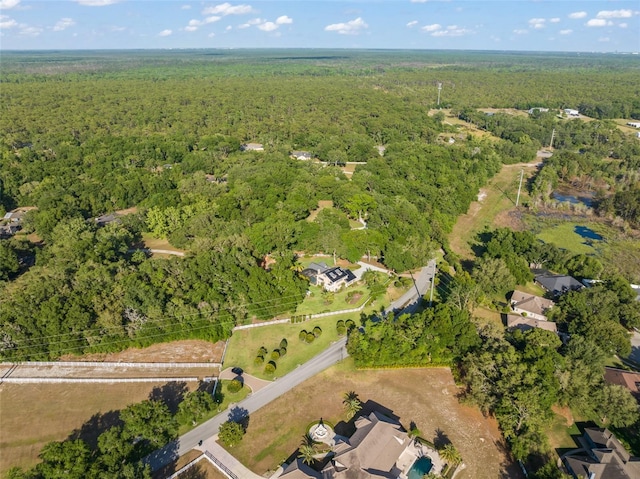 birds eye view of property featuring a wooded view