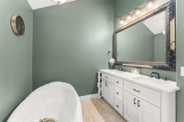 full bath with double vanity, tile patterned floors, a sink, and a bath