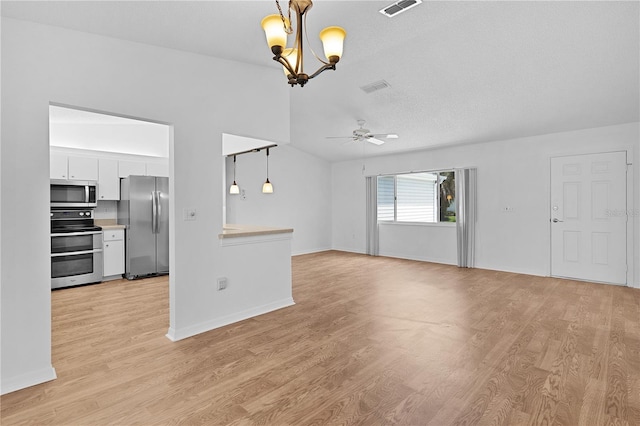 unfurnished living room with baseboards, ceiling fan with notable chandelier, light wood-type flooring, and visible vents
