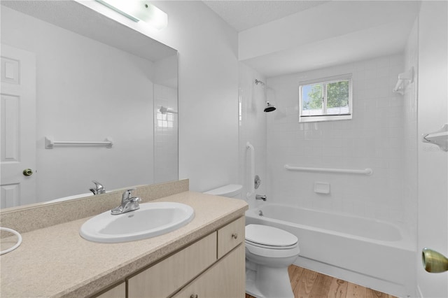 bathroom featuring shower / bathtub combination, toilet, wood finished floors, and vanity