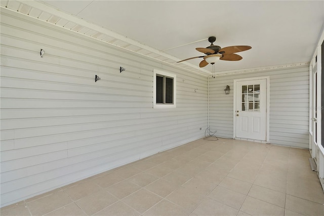 unfurnished sunroom with ceiling fan