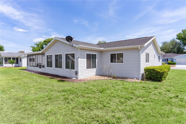 back of house with a sunroom and a lawn