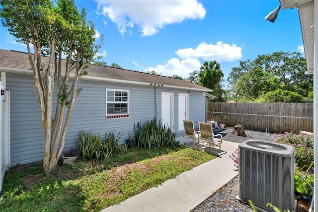 506 Richard St, Leesburg, FL 34748 - view of property exterior featuring central AC, fence, and a patio area