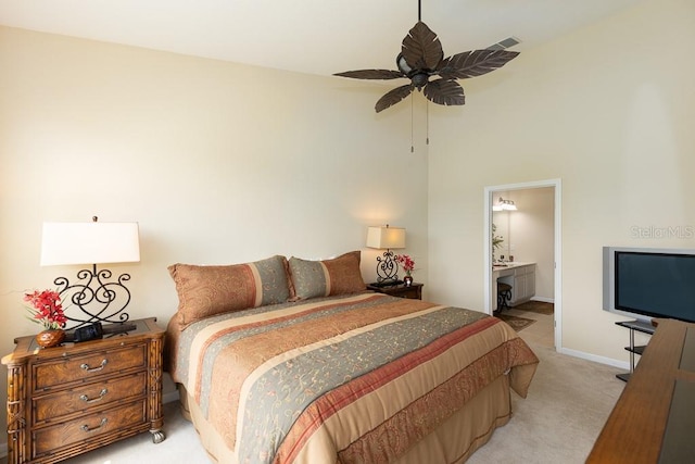 1288 Grady Ln, Davenport, FL 33896 - bedroom featuring light colored carpet, ensuite bathroom, and ceiling fan