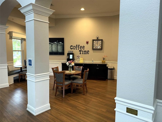 1288 Grady Ln, Davenport, FL 33896 - dining room featuring decorative columns, dark wood-style flooring, arched walkways, crown molding, and recessed lighting