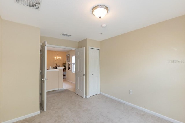 1288 Grady Ln, Davenport, FL 33896 - unfurnished bedroom with a chandelier, light carpet, and a closet