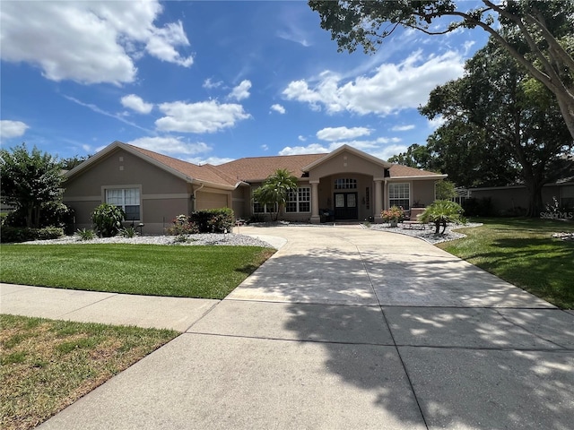 view of front facade featuring a garage, stucco siding, concrete driveway, and a front yard