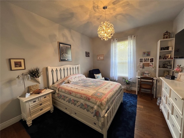 bedroom featuring an inviting chandelier, dark wood finished floors, and baseboards