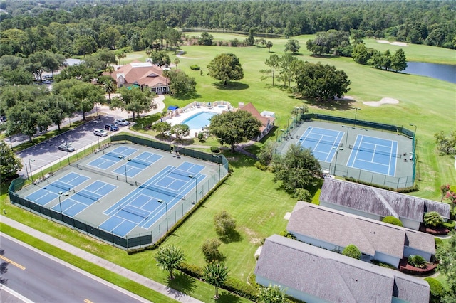 drone / aerial view with a water view and golf course view