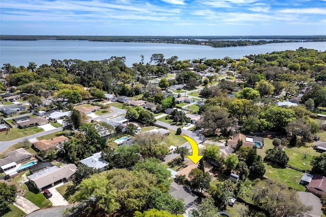 drone / aerial view with a residential view and a water view