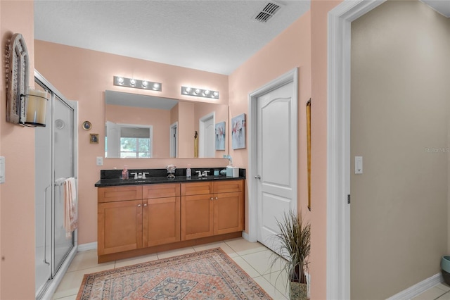3441 Landing Vw, Tavares, FL 32778 - bathroom with a shower stall, vanity, tile patterned floors, and baseboards