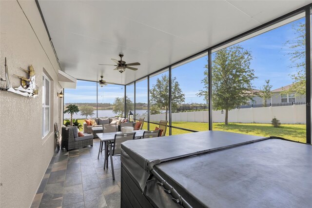 3441 Landing Vw, Tavares, FL 32778 - sunroom with a textured wall, stone tile floors, a water view, and expansive windows