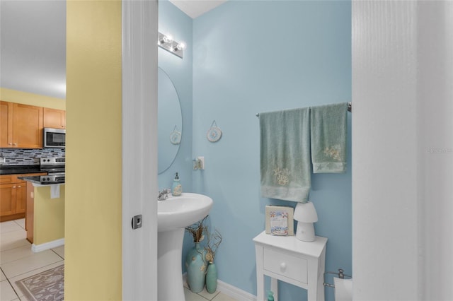 3441 Landing Vw, Tavares, FL 32778 - bathroom with tile patterned floors, decorative backsplash, and a sink