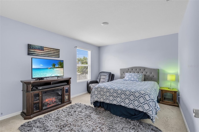 3441 Landing Vw, Tavares, FL 32778 - carpeted bedroom featuring baseboards and a glass covered fireplace