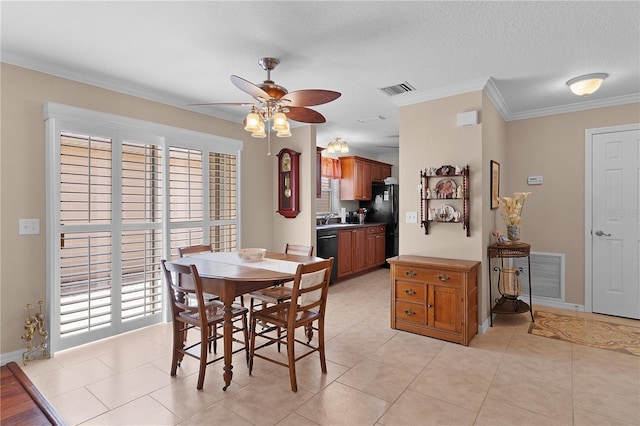 dining area featuring light tile patterned floors, visible vents, a ceiling fan, and ornamental molding