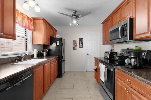 kitchen featuring ornamental molding, ceiling fan, a sink, black appliances, and dark countertops