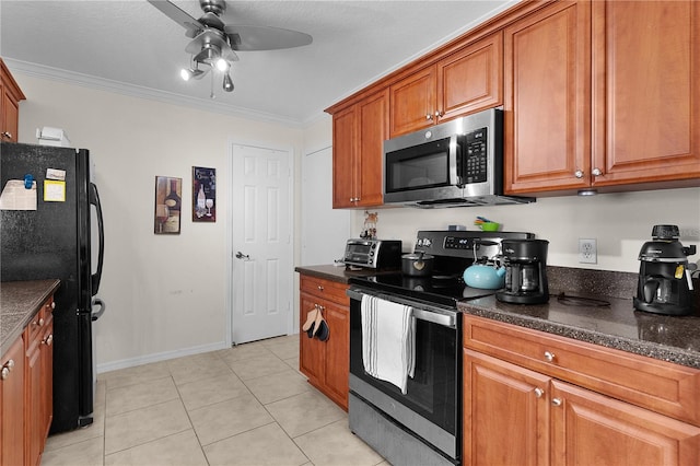kitchen featuring a ceiling fan, light tile patterned floors, ornamental molding, brown cabinets, and stainless steel appliances