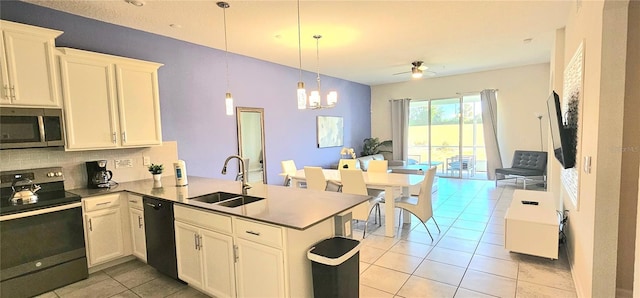 817 Ocean Course Ave Unit 502, Davenport, FL 33896 - kitchen with electric stove, a sink, stainless steel microwave, dishwasher, and open floor plan