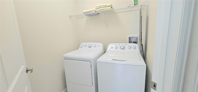 817 Ocean Course Ave Unit 502, Davenport, FL 33896 - laundry room featuring washer and clothes dryer and a textured wall