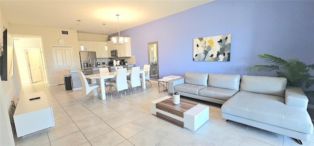 817 Ocean Course Ave Unit 502, Davenport, FL 33896 - living room with a chandelier and light tile patterned floors