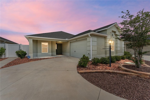 9181 SE 166th Sprung Ln, The Villages, FL 32162 - single story home with fence, an attached garage, stucco siding, concrete driveway, and roof with shingles