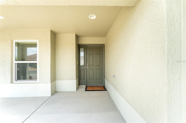 9181 SE 166th Sprung Ln, The Villages, FL 32162 - doorway to property featuring stucco siding