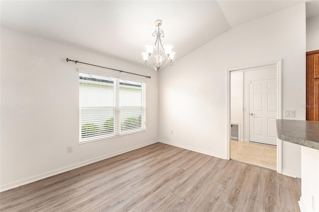 9181 SE 166th Sprung Ln, The Villages, FL 32162 - unfurnished room with light wood finished floors, lofted ceiling, a notable chandelier, and baseboards
