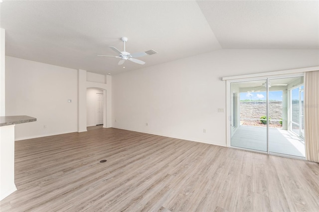 9181 SE 166th Sprung Ln, The Villages, FL 32162 - unfurnished living room with ceiling fan, vaulted ceiling, light wood-style flooring, and arched walkways