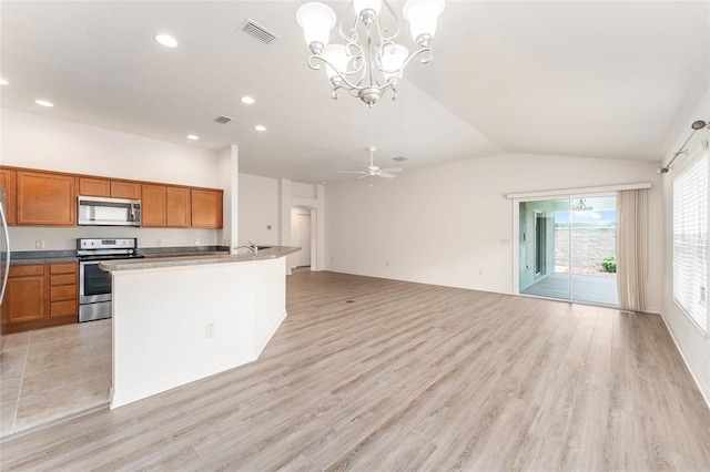 9181 SE 166th Sprung Ln, The Villages, FL 32162 - kitchen featuring brown cabinets, stainless steel appliances, open floor plan, visible vents, and recessed lighting