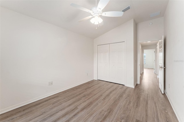 9181 SE 166th Sprung Ln, The Villages, FL 32162 - unfurnished bedroom featuring lofted ceiling, a closet, visible vents, light wood finished floors, and baseboards