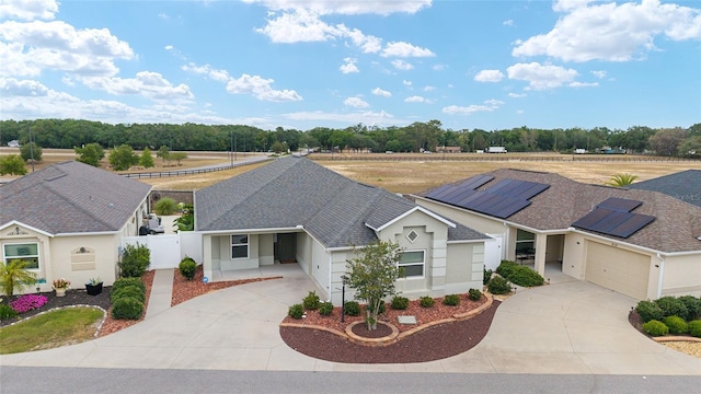 9181 SE 166th Sprung Ln, The Villages, FL 32162 - ranch-style house with concrete driveway, stucco siding, fence, and a garage