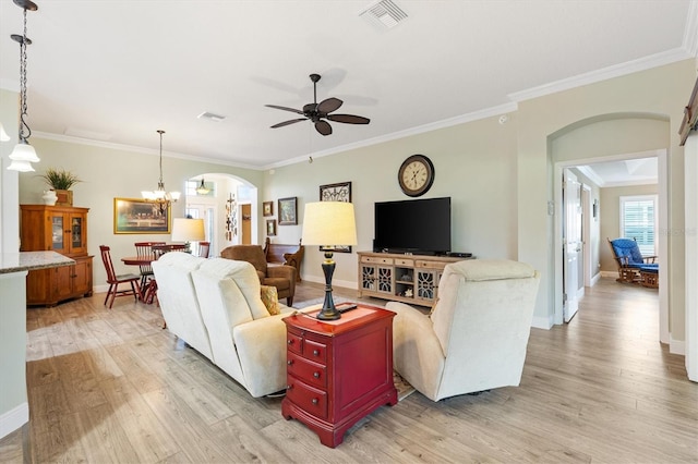 1182 Allaire Loop, The Villages, FL 32163 - living room featuring arched walkways, light wood-style flooring, ceiling fan, ornamental molding, and baseboards