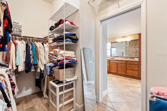 1182 Allaire Loop, The Villages, FL 32163 - walk in closet with light wood-type flooring
