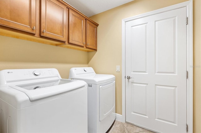 1182 Allaire Loop, The Villages, FL 32163 - laundry room featuring washing machine and clothes dryer, cabinet space, light tile patterned floors, and baseboards