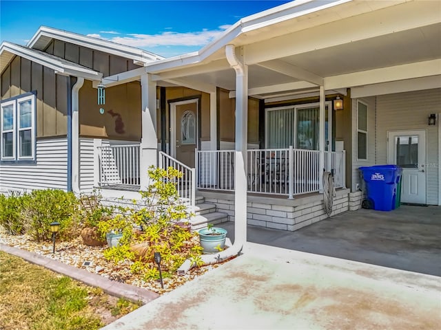 1236 Elkhart Cir, Tavares, FL 32778 - property entrance featuring covered porch and board and batten siding