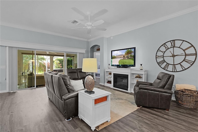 3433 Nestlebranch Ave, The Villages, FL 32163 - living room with ceiling fan, visible vents, crown molding, arched walkways, and wood finished floors
