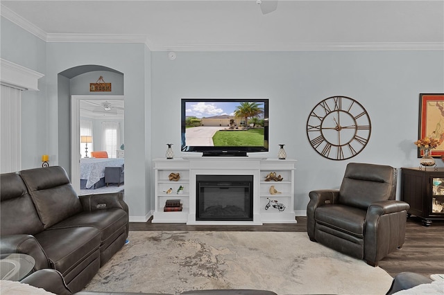 3433 Nestlebranch Ave, The Villages, FL 32163 - living area with dark wood-style flooring, baseboards, a glass covered fireplace, and ornamental molding