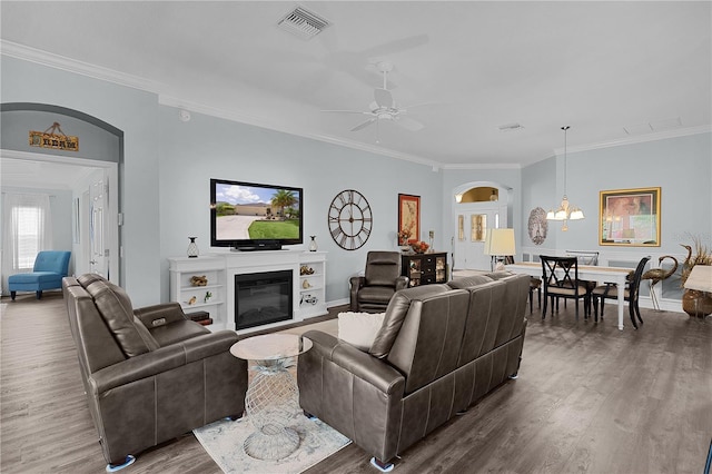 3433 Nestlebranch Ave, The Villages, FL 32163 - living area featuring crown molding, arched walkways, wood finished floors, and visible vents