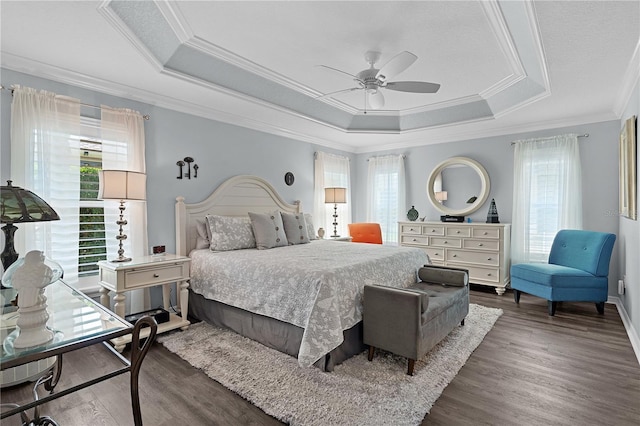 3433 Nestlebranch Ave, The Villages, FL 32163 - bedroom with ornamental molding, wood finished floors, a tray ceiling, and multiple windows