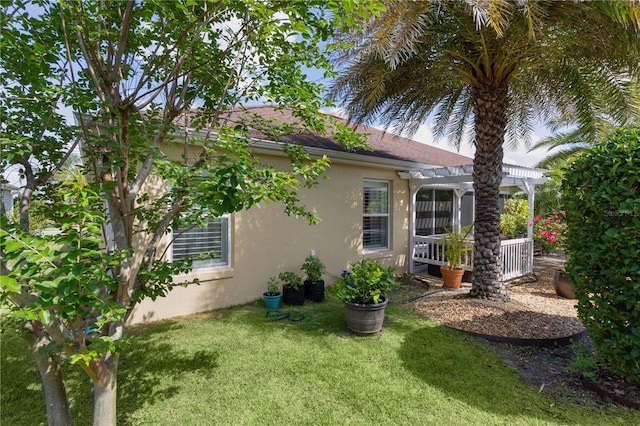 3433 Nestlebranch Ave, The Villages, FL 32163 - view of property exterior featuring a pergola, stucco siding, and a yard